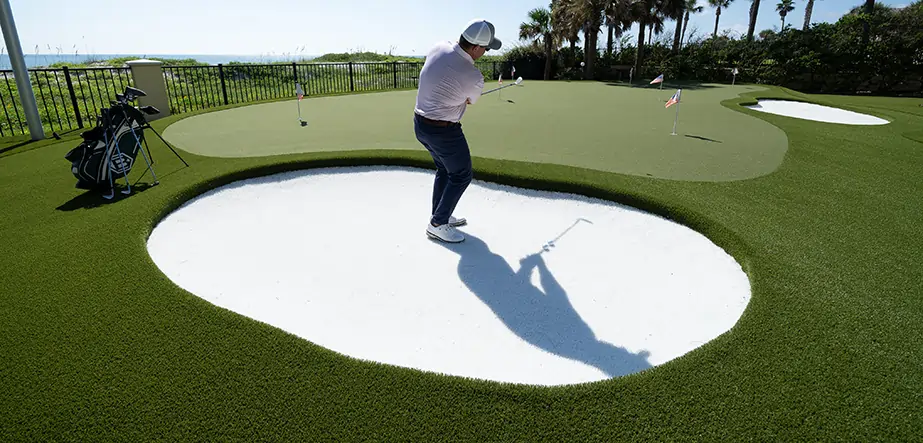 Golfer practicing on chipping green from SYNLawn